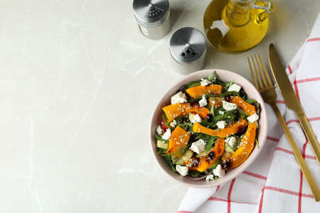Concept of tasty food with pumpkin salad on light backgroundの写真素材