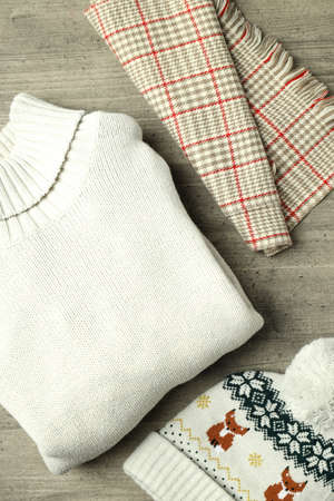 Concept of winter clothes on gray wooden table.の写真素材