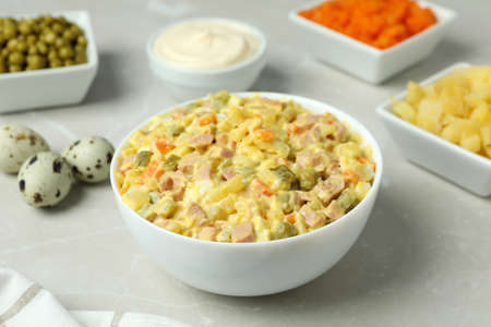 Olivier salad and ingredients on light backgroundの写真素材