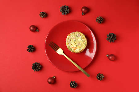 Christmas concept of tasty food with Olivier salad on red backgroundの写真素材