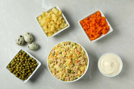 Olivier salad and ingredients on light backgroundの写真素材