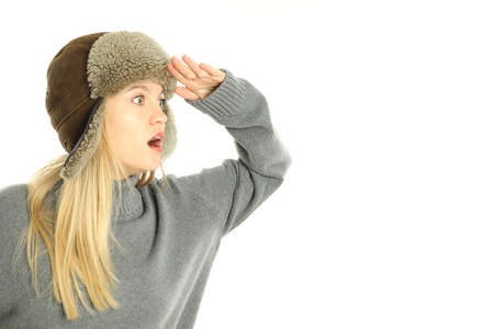 Attractive girl in fur cap isolated on white background.