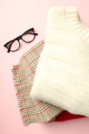 Sweaters, scarf and glasses on pink background.の写真素材
