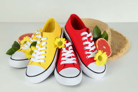 Summer clothes concept with sneakers on white background