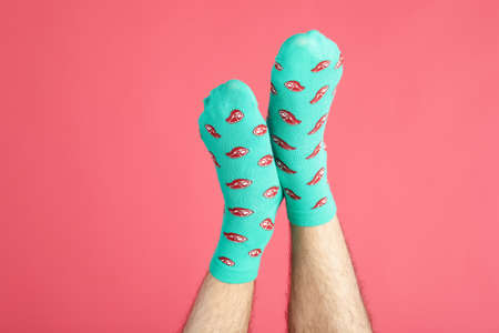 Male legs in socks with meat slices on pink backgroundの写真素材