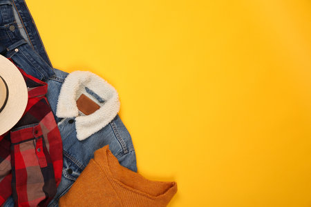 Concept of winter clothes on yellow background.の写真素材