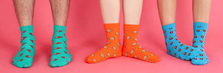 Legs in different socks on pink backgroundの写真素材