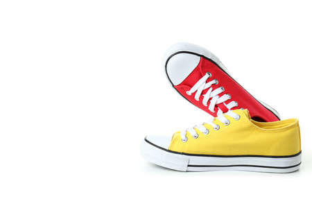 Pair of red and yellow sneakers isolated on white backgroundの写真素材