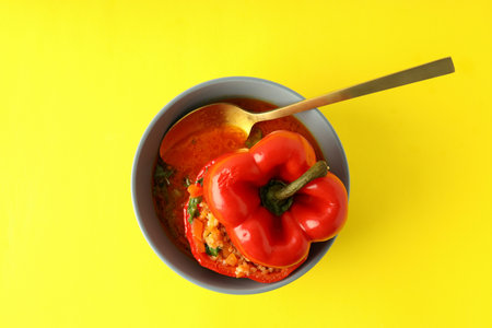 Stuffed pepper in bowl on yellow backgroundの写真素材