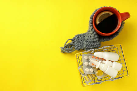 Flu treatment accessories on yellow background, space for text