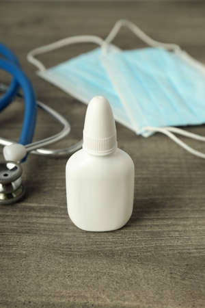 Nasal spray, medical mask and stethoscope on gray textured backgroundの写真素材
