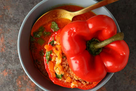 Stuffed pepper in bowl on dark textured background