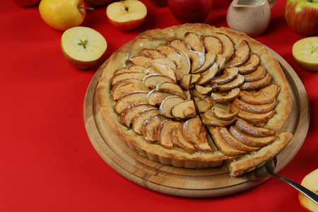Concept of tasty food with apple pie on red backgroundの写真素材