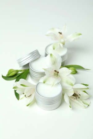 Eco lip balm and flowers on white backgroundの写真素材