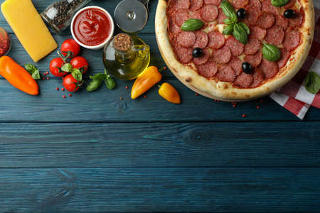 Concept of tasty food with Salami pizza on wooden tableの写真素材