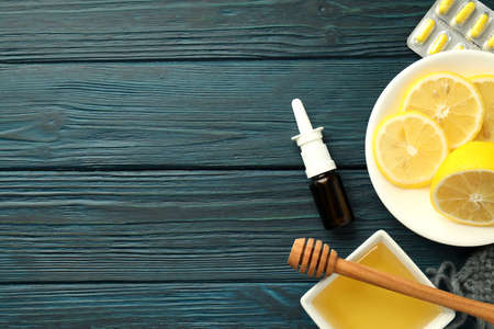 Flu treatment accessories on wooden table, space for textの写真素材