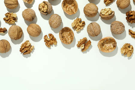 Flat lay composition with walnuts on brown background