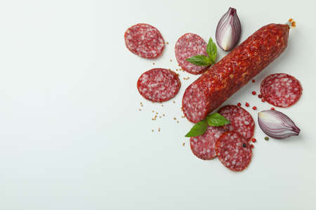 Ð¡oncept of tasty food with salami sausage on white backgroundの写真素材