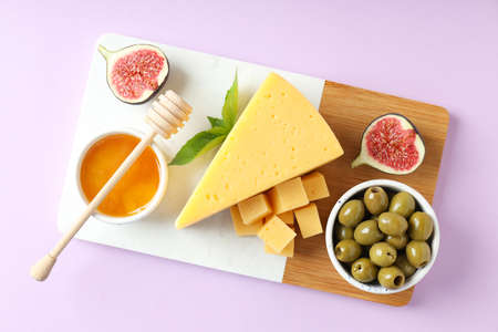 Concept of cooking eating with hard cheese on purple background