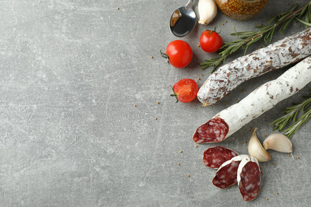 Ð¡oncept of tasty food with salami sausage on gray textured backgroundの写真素材