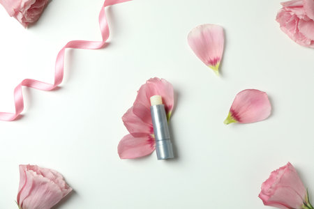 Hygienic lipstick and roses on white backgroundの写真素材