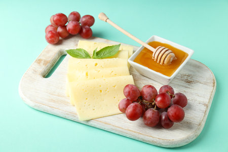 Concept of cooking eating with hard cheese on mint backgroundの写真素材