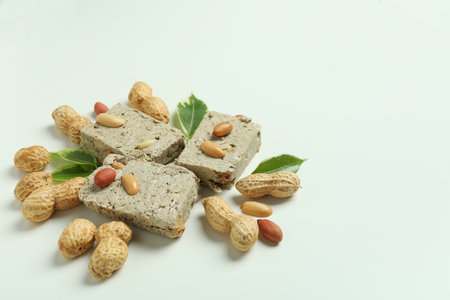 Concept of tasty food with halva and nuts on white backgroundの写真素材