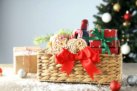 Concept of gift with Christmas basket on white wooden table