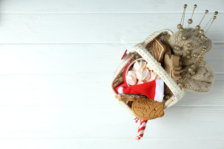 Concept of gift with Christmas basket on white wooden backgroundの写真素材