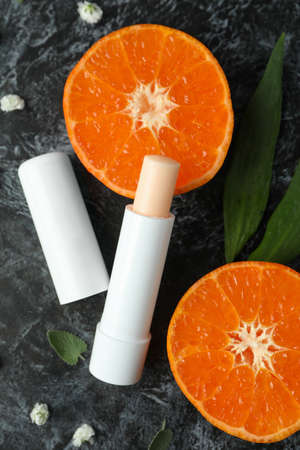 Concept of cosmetic with eco hygienic lipstick on dark background