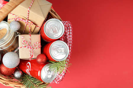 Odessa, Ukraine - November 10, 2021: Concept of gift with Christmas basket, red backgroundのeditorial素材