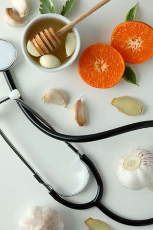 Concept of treatment colds with honey and garlic on white backgroundの写真素材
