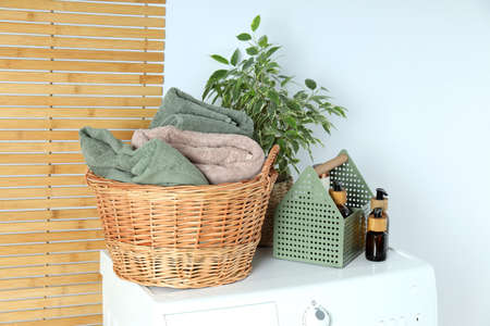 Concept of housework with washing machine on white background