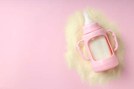 Concept of baby food with powdered milk on pink backgroundの写真素材