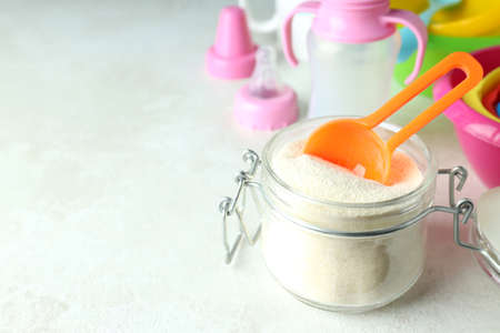 Concept of baby food with powdered milk on white textured backgroundの写真素材