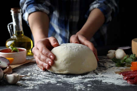 Concept of cooking pizza on dark textured tableの写真素材