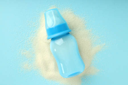 Concept of baby food with powdered milk on blue backgroundの写真素材