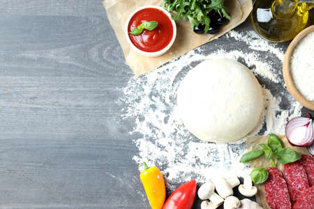 Concept of cooking pizza on gray wooden backgroundの写真素材
