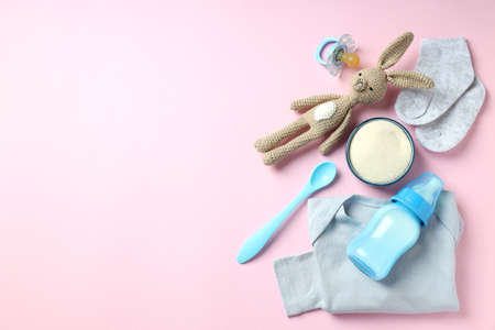 Concept of baby food with powdered milk on pink backgroundの写真素材