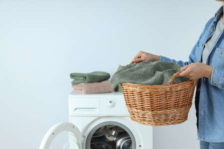 Concept of housework with washing machine and girl on white backgroundの写真素材