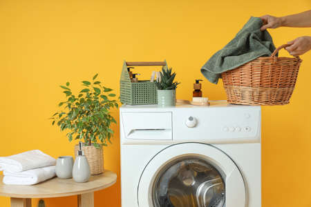 Concept of housework with washing machine on yellow backgroundの写真素材