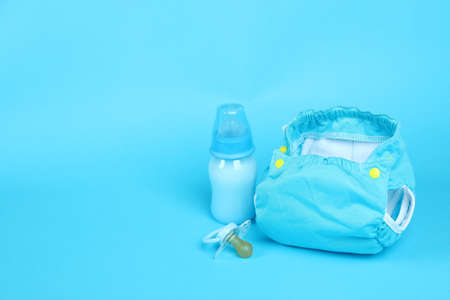 Concept of baby clothes with reusable diapers on blue backgroundの写真素材
