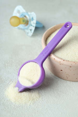 Concept of baby food with powdered milk on white textured backgroundの写真素材