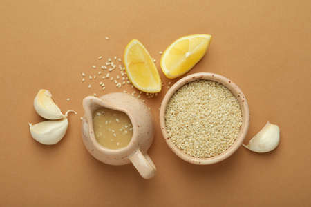 Concept of tasty food with tahini sauce on beige backgroundの写真素材