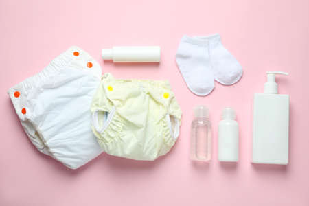 Concept of baby clothes with reusable diapers on pink backgroundの写真素材