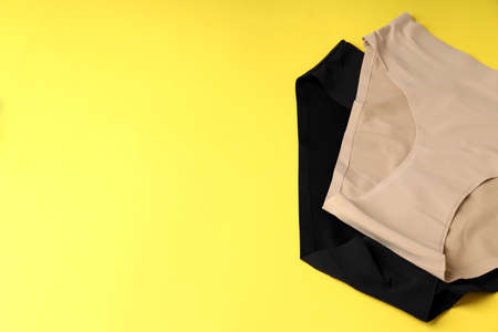 Concept of women's clothes with panties on yellow backgroundの写真素材