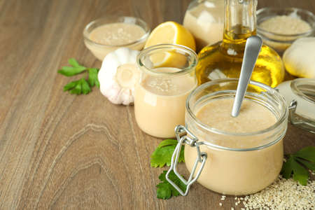 Concept of tasty food with tahini sauce on wooden backgroundの写真素材