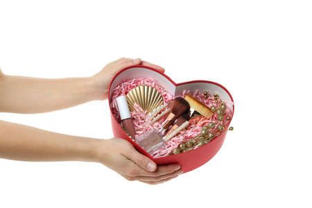 Woman hands hold female gift box, isolated on white backgroundの写真素材