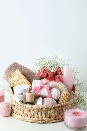 Concept of gift with basket of cosmetics on white tableの写真素材