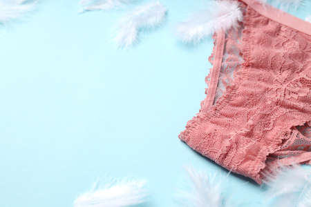 Concept of women's clothes with panties on blue background